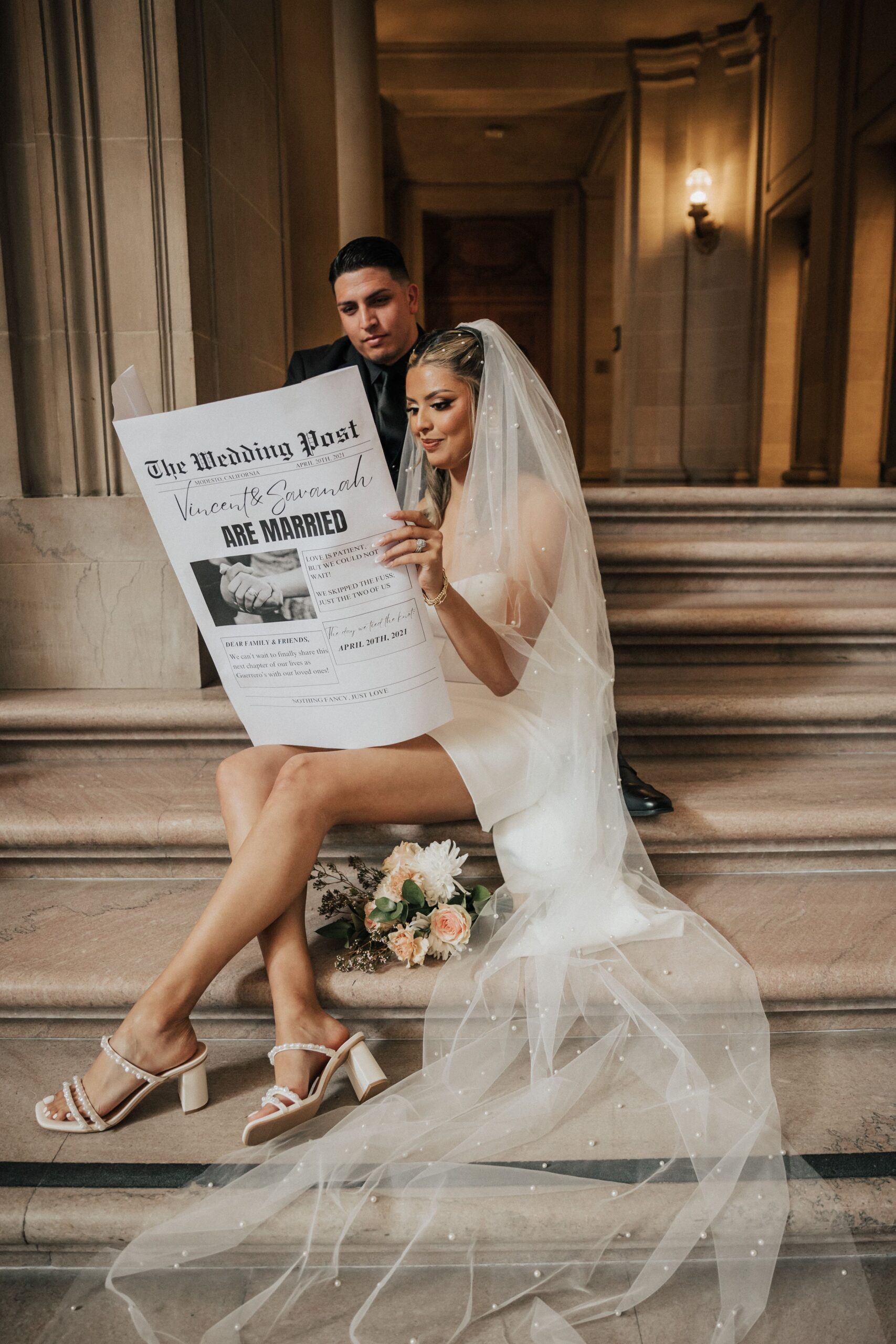 bride and groom with elopement announcement newspaper