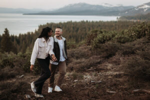 Engaged couple shares a sunrise kiss on a mountaintop in Lake Tahoe