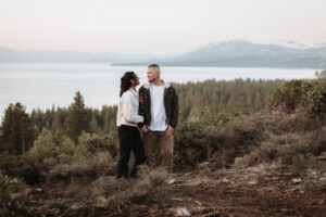 Couple embraces on a scenic overlook at sunrise in Lake Tahoe