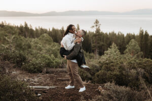 Fiancé lifts his partner in a joyful moment at sunrise in Lake Tahoe