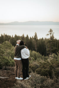 Sunrise glow highlights an engaged couple sharing a quiet moment in Lake Tahoe