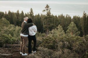 Romantic Lake Tahoe engagement session with the couple wrapped in golden morning light