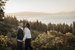 Engaged couple watches the sunrise over the mountains in Lake Tahoe