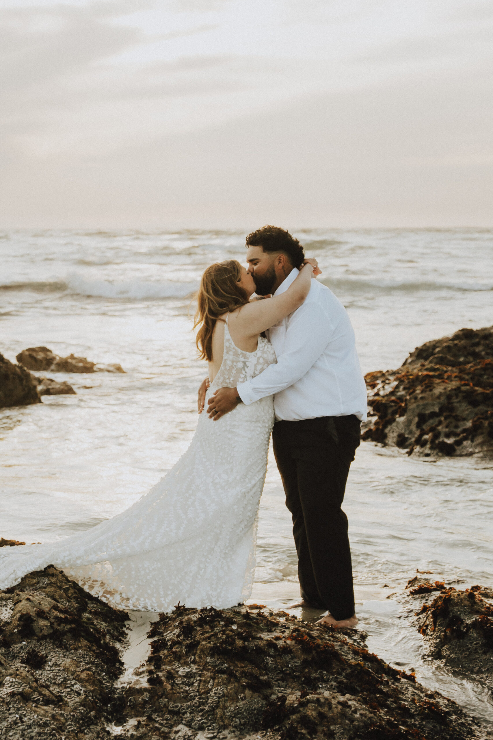 bride and groom on monterey beach