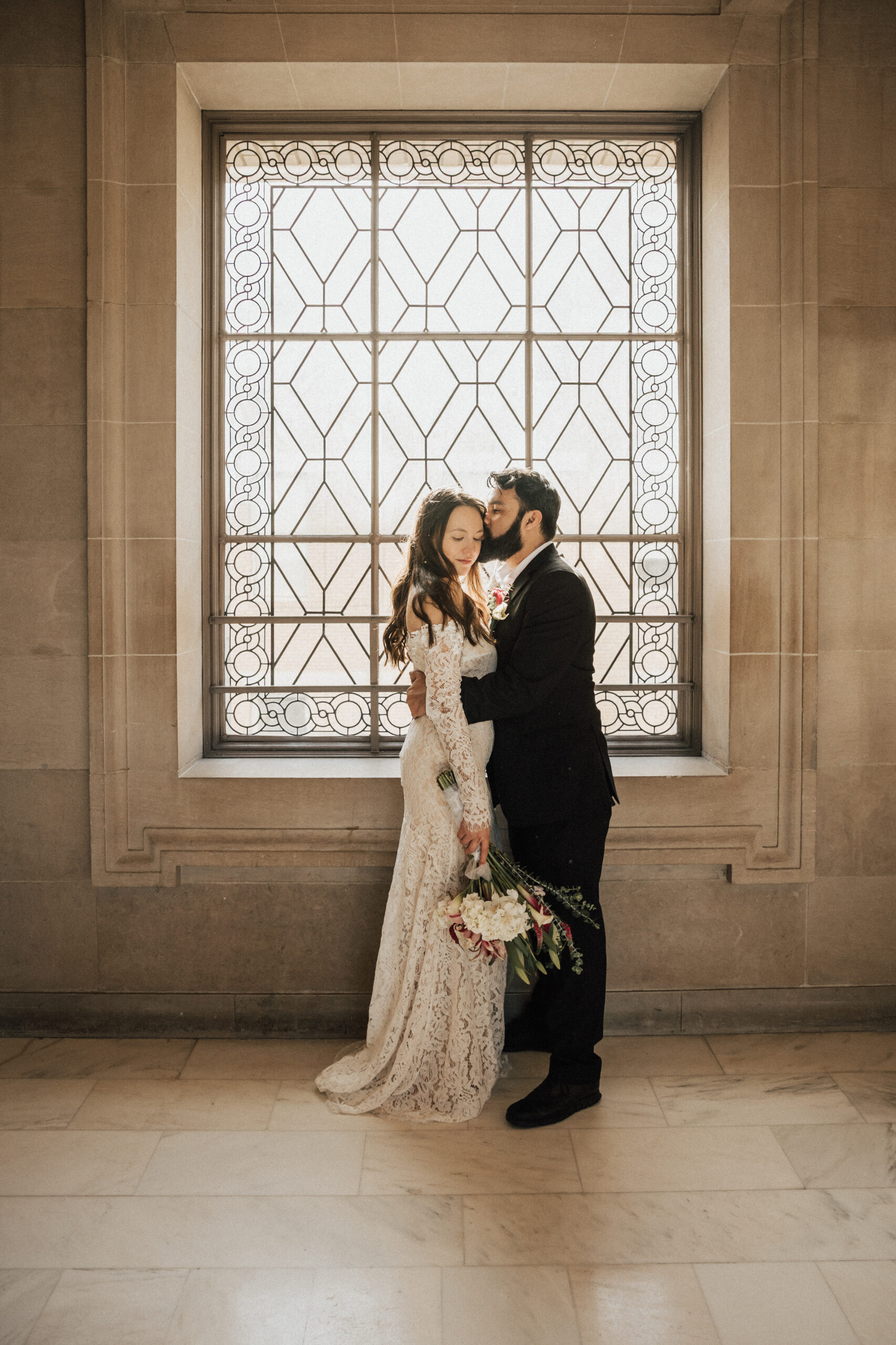 San francisco city hall couple in front of window